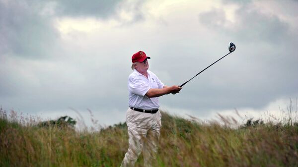 Donald Trump plays a stroke as he officially opens his new multi-million pound Trump International Golf Links course in Aberdeenshire, Scotland, on July 10, 2012 - Sputnik International