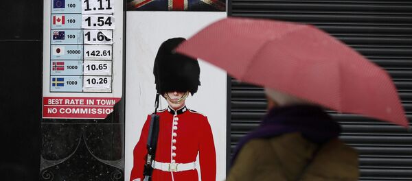 A pedestrian shelters under an umbrella as she walks past a money exchange sign in central London, Britain January 16, 2017. A pedestrian shelters under an umbrella as she walks past a money exchange sign in central London, Britain January 16, 2017. - Sputnik International