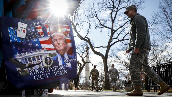 Military personnel walk along the National Mall in Washington, Wednesday, Jan. 18, 2017, alongside vendors selling President-elect Donald Trump merchandise ahead of Friday's presidential inauguration - Sputnik International