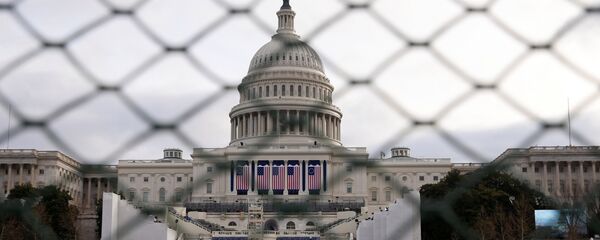 The U.S. Capitol building is seen behind a security fence in Washington ahead of the 2017 Presidential Inauguation. - Sputnik International