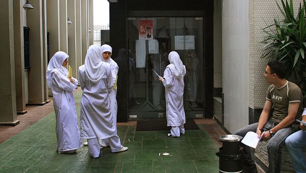 Young nurses wearing Islamic head-coverings stand at the entrance of the Medical Library at Rassoul al-Azaem Hospital, on the edge of the devastated southern suburbs of Beirut, 08 September 2006 - Sputnik International