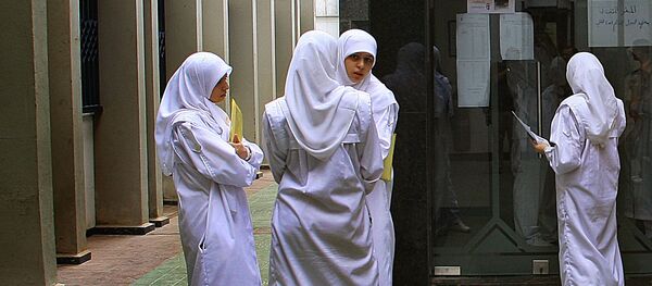 Young nurses wearing Islamic head-coverings stand at the entrance of the Medical Library at Rassoul al-Azaem Hospital, on the edge of the devastated southern suburbs of Beirut, 08 September 2006 Young nurses wearing Islamic head-coverings stand at the entrance of the Medical Library at Rassoul al-Azaem Hospital, on the edge of the devastated southern suburbs of Beirut, 08 September 2006 - Sputnik International