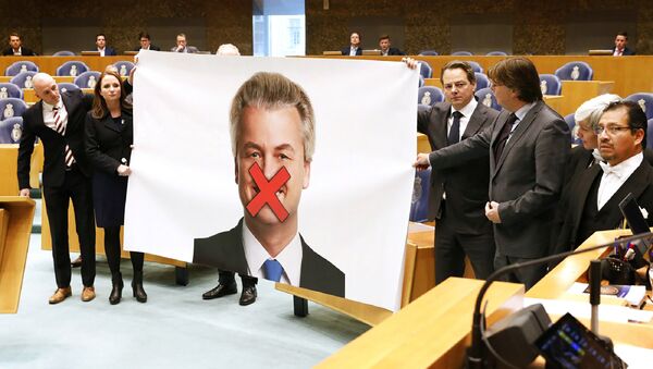 Members of right-wing Dutch Party for Freedom (Partij voor de Vrijheid - PVV) protest against the sentence demanded for their leader Geert Wilders with a large poster of Wilders displayed with a red cross over his mouth, in the Senate (Tweede Kamer) at the Binnenhof in The Hague - Sputnik International