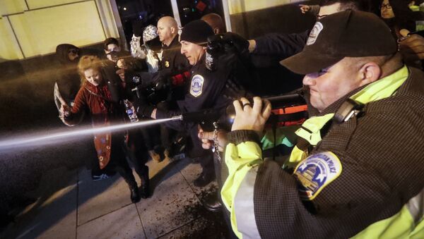Police unleash pepper spray on protestors during an altercation on 14th Street ahead of the presidential inauguration, Thursday, Jan. 19, 2017, in Washington - Sputnik International