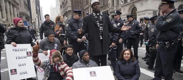 Police officers prepare to take New York City Councilman Jumaane Williams, center, into custody after he and others blocked traffic on Fifth Avenue outside Trump Tower in New York, Friday, Jan. 20, 2017, during a protest during President Donald Trump's inauguration. Police officers prepare to take New York City Councilman Jumaane Williams, center, into custody after he and others blocked traffic on Fifth Avenue outside Trump Tower in New York, Friday, Jan. 20, 2017, during a protest during President Donald Trump's inauguration. - Sputnik International