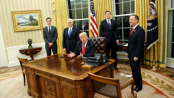 US President Donald Trump, flanked by Senior Advisor Jared Kushner (standing, L-R), Vice President Mike Pence, Staff Secretary Rob Porter and Chief of Staff Reince Priebus, welcomes reporters into the Oval Office for him to sign his first executive orders at the White House in Washington, US January 20, 2017. - Sputnik International