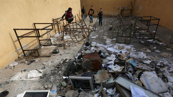 Students stand amid damaged desks and books in 'Aisha Mother of the BelieversÕ school which was recently reopened after rebels took control of al-Rai town from Islamic State militants, Syria January 17, 2017 - Sputnik International