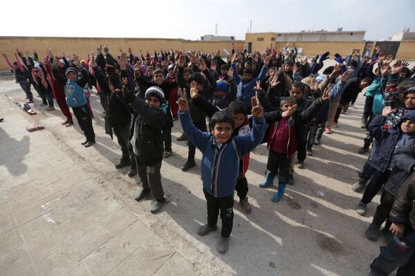 Students gesture as they stand in line at the 'Aisha Mother of the BelieversÕ school which was recently reopened after rebels took control of al-Rai town from Islamic State militants, Syria January 16, 2017 Students gesture as they stand in line at the 'Aisha Mother of the BelieversÕ school which was recently reopened after rebels took control of al-Rai town from Islamic State militants, Syria January 16, 2017 - Sputnik International