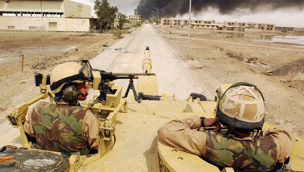 Alex Matheson, left, a member of the Desert Rats with his Challenger II tank man an operational post in Basra, southern Iraq, Friday April 4, 2003 - Sputnik International