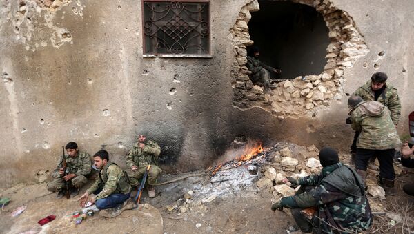 Rebel fighters rest near a hole in the wall by a fire on the outskirts of the northern Syrian town of al-Bab, Syria January 15, 2017 - Sputnik International