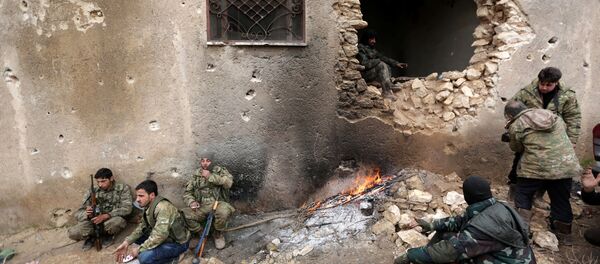 Rebel fighters rest near a hole in the wall by a fire on the outskirts of the northern Syrian town of al-Bab, Syria January 15, 2017 Rebel fighters rest near a hole in the wall by a fire on the outskirts of the northern Syrian town of al-Bab, Syria January 15, 2017 - Sputnik International