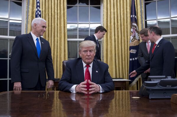 US President Donald Trump (C) waits at his desk before signing confirmations for James Mattis as US Secretary of Defense and John Kelly as US Secretary of Homeland Security, as Vice President Mike Pence (L) and White House Chief of Staff Reince Priebus (R) look on, in the Oval Office of the White House in Washington, DC, January 20, 2017 US President Donald Trump (C) waits at his desk before signing confirmations for James Mattis as US Secretary of Defense and John Kelly as US Secretary of Homeland Security, as Vice President Mike Pence (L) and White House Chief of Staff Reince Priebus (R) look on, in the Oval Office of the White House in Washington, DC, January 20, 2017 - Sputnik International
