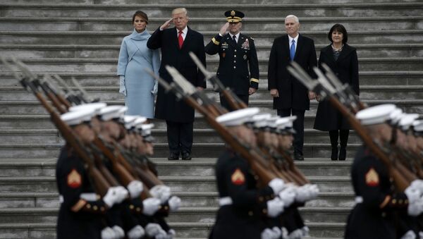 Newly inaugurated U.S. President Donald Trump (in red tie), first lady Melania (L), Vice President Mike Pence and his wife Karen (R) preside over a military parade during Trump's swearing ceremony in Washington, U.S., January 20, 2017 - Sputnik International