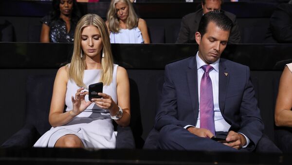 Republican Presidential Candidate Donald Trump's children Ivanka Trump and Donald Trump Jr., check on their phones during the second day session of the Republican National Convention in Cleveland, Tuesday, July 19, 2016. - Sputnik International