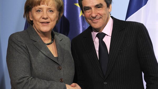German Chancellor Angela Merkel (L) and French Prime Minister Francois Fillon shake hands after a press conference following talks at the chancellery in Berlin March 10, 2010. T - Sputnik International
