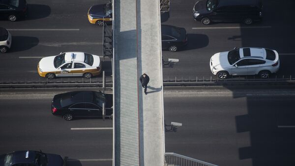 A pedestrian walks on a bridge over the second ring road in Beijing (file) - Sputnik International
