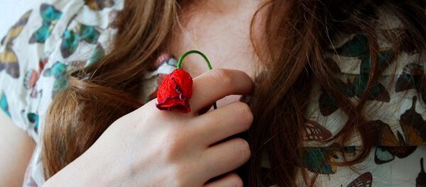 A woman holding a flower - Sputnik International