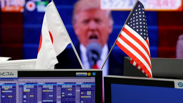 National flags of Japan and the U.S. are seen in front of a monitor showing U.S. President Donald Trump at a foreign exchange trading company in Tokyo, Japan, January 23, 2017 - Sputnik International