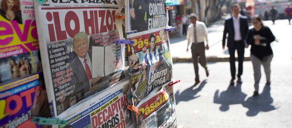 A front page newspaper headline reads He did it! over a picture of U.S. President Donald Trump holding up signed documents, as he took action to jumpstart construction on a promised border wall, in Mexico City, Thursday, Jan. 26, 2017 - Sputnik International