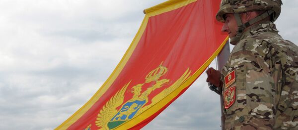 Montenegrin Army soldiers fire artillery look at the Montenegro flag during preparations on the eve of Independence day, on May 20, 2010 in Cetinje Montenegrin Army soldiers fire artillery look at the Montenegro flag during preparations on the eve of Independence day, on May 20, 2010 in Cetinje - Sputnik International