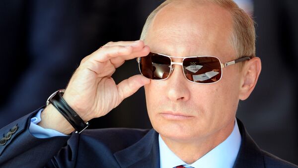 Russian Prime Minister Vladimir Putin adjusts his sunglasses as he watches an air show during MAKS-2011, the International Aviation and Space Show, in Zhukovsky, outside Moscow, on August 17, 2011 - Sputnik International