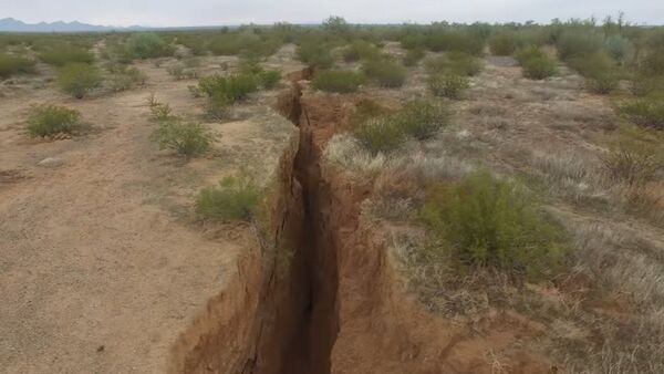 A 1.8 mile long fissure discovered in the Arizona desert. The fissure runs as much as 10 feet wide and 30 feet deep. A 1.8 mile long fissure discovered in the Arizona desert. The fissure runs as much as 10 feet wide and 30 feet deep. - Sputnik International