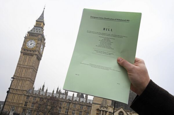 A journalist poses with a copy of the Brexit Article 50 bill, introduced by the government to seek parliamentary approval to start the process of leaving the European Union, in front of the Houses of Parliament in London, Britain, January 26, 2017 - Sputnik International