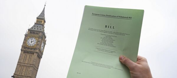 A journalist poses with a copy of the Brexit Article 50 bill, introduced by the government to seek parliamentary approval to start the process of leaving the European Union, in front of the Houses of Parliament in London, Britain, January 26, 2017 - Sputnik International