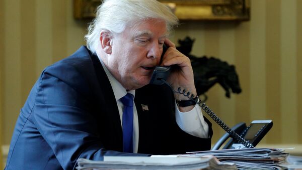U.S. President Donald Trump speaks by phone with Russia's President Vladimir Putin in the Oval Office at the White House in Washington, U.S. January 28, 2017 - Sputnik International