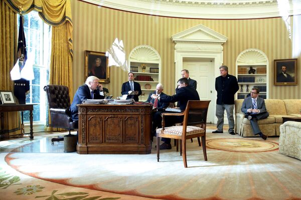 U.S. President Donald Trump (from L), joined by Chief of Staff Reince Priebus, Vice President Mike Pence, National Security Advisor Michael Flynn, Communications Director Sean Spicer and senior advisor Steve Bannon, speaks by phone with Russia's President Vladimir Putin in the Oval Office at the White House in Washington, U.S. January 28, 2017 - Sputnik International