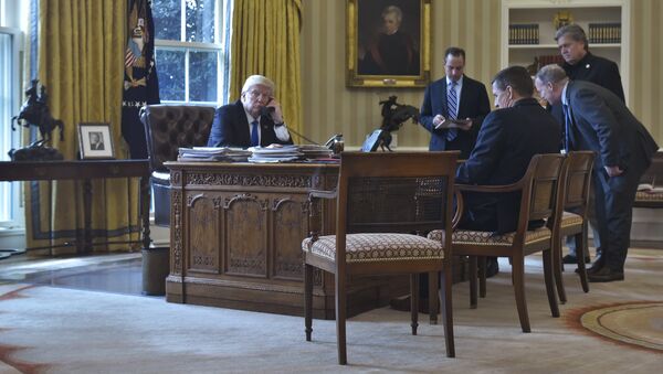US President Donald Trump speaks on the phone with Russia's President Vladimir Putin from the Oval Office of the White House on January 28, 2017, in Washington, DC - Sputnik International