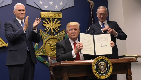 US President Donald Trump shows his signature on executive orders alongside US Defense Secretary James Mattis and US Vice President Mike Pence on January 27, 2017, at the Pentagon in Washington, DC - Sputnik International