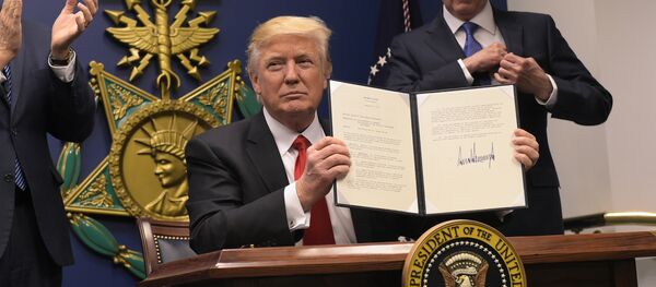 US President Donald Trump shows his signature on executive orders alongside US Defense Secretary James Mattis and US Vice President Muike Pence on January 27, 2017, at the Pentagon in Washington, DC - Sputnik International