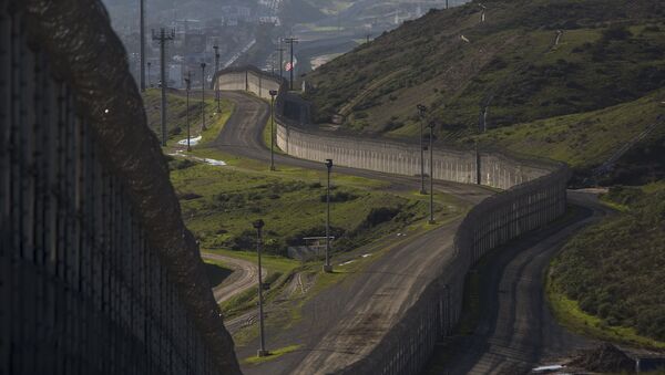 Multiple layers of steel walls, fences, razor wire and other barricades are viewed from the United States side of the of the US-Mexico border on January 26, 2017 in San Ysidro, California - Sputnik International