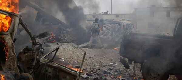 A rebel fighter walks near damaged vehicles after a car bomb explosion in Jub al Barazi east of the northern Syrian town of al-Bab, Syria January 15, 2017 A rebel fighter walks near damaged vehicles after a car bomb explosion in Jub al Barazi east of the northern Syrian town of al-Bab, Syria January 15, 2017 - Sputnik International