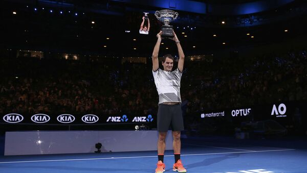 Switzerland's Roger Federer holds up the trophy after winning his Men's singles final match against Spain's Rafael Nadal - Sputnik International
