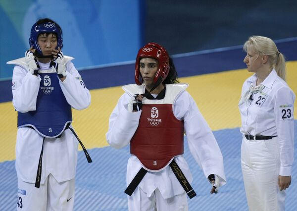 United Arab Emirates Princess Sheikh Maitha Almaktoum (C) walks after her match with Kyungseon Hwang of South Korea (L) during their women's -67 kg taekwondo priliminary at the 2008 Beijing Olympic Games in Beijing on August 22, 2008 - Sputnik International