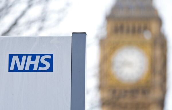 An NHS sign is pictured at St Thomas' Hospital in front of the Big Ben clock face and the Elizabeth Tower on January 13, 2017 in London. An NHS sign is pictured at St Thomas' Hospital in front of the Big Ben clock face and the Elizabeth Tower on January 13, 2017 in London. - Sputnik International