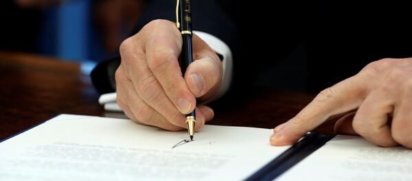 U.S. President Donald Trump signs a memorandum to security services directing them to defeat the Islamic State in the Oval Office at the White House in Washington, U.S. January 28, 2017 - Sputnik International