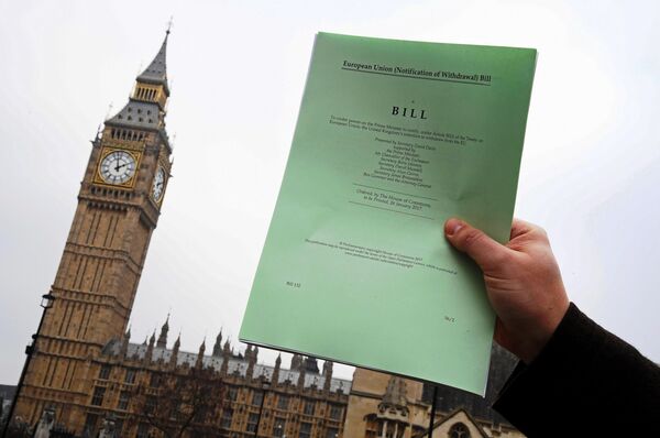 A journalist poses with a copy of the Brexit Article 50 bill, introduced by the government to seek parliamentary approval to start the process of leaving the European Union, in front of the Houses of Parliament in London, Britain, January 26, 2017. A journalist poses with a copy of the Brexit Article 50 bill, introduced by the government to seek parliamentary approval to start the process of leaving the European Union, in front of the Houses of Parliament in London, Britain, January 26, 2017. - Sputnik International