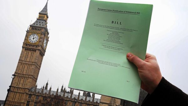 A journalist poses with a copy of the Brexit Article 50 bill, introduced by the government to seek parliamentary approval to start the process of leaving the European Union, in front of the Houses of Parliament in London, Britain, January 26, 2017. - Sputnik International