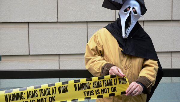 A demonstrator from 'Stop G8' is pictured outside the offices of BAE Systems in London on June 12, 2013, during a protest against the G8 Summit. - Sputnik International