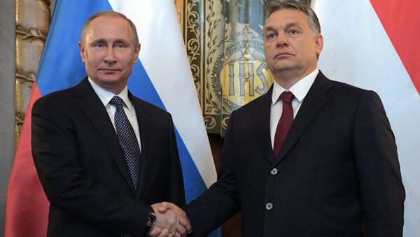 Hungarian Prime Minister Viktor Orban (R) and Russian President Vladimir Putin attend a news conference following their talks in Budapest, Hungary - Sputnik International