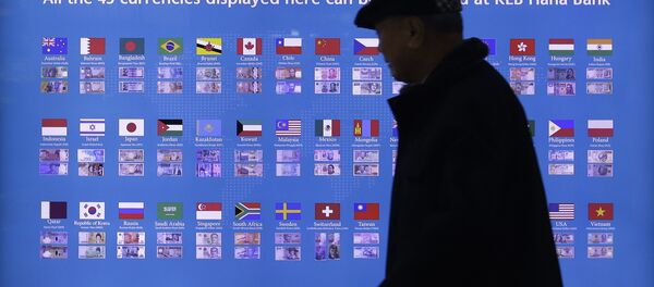 A man walks by a board displaying various banknotes issued in the world at a subway station in Seoul, South Korea. - Sputnik International