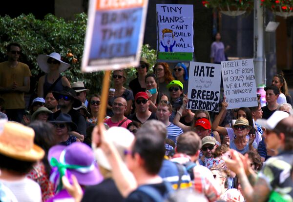 Protesters hold placards as they stand together in Sydney, Australia, February 4, 2017 during one of several rallies across Australia condemning US President Donald Trump's order temporarily barring refugees and nationals from seven countries and demanding an end to Australia's offshore detention of asylum seekers. Protesters hold placards as they stand together in Sydney, Australia, February 4, 2017 during one of several rallies across Australia condemning US President Donald Trump's order temporarily barring refugees and nationals from seven countries and demanding an end to Australia's offshore detention of asylum seekers. - Sputnik International