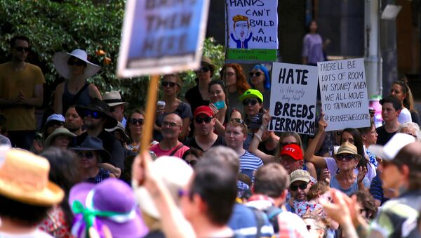 Protesters hold placards as they stand together in Sydney, Australia, February 4, 2017 during one of several rallies across Australia condemning U.S. President Donald Trump's order temporarily barring refugees and nationals from seven countries and demanding an end to Australia's offshore detention of asylum seekers - Sputnik International