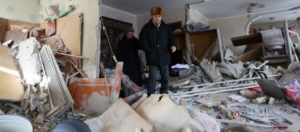Local residents examine their flat that has been destroyed as a result of night shelling to the flashpoint eastern town of Avdiivka Local residents examine their flat that has been destroyed as a result of night shelling to the flashpoint eastern town of Avdiivka - Sputnik International