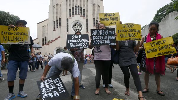Human rights activists display placards outside the Baclaran Church prior to a mass in suburban Paranaque, south of Manila, Philippines. - Sputnik International