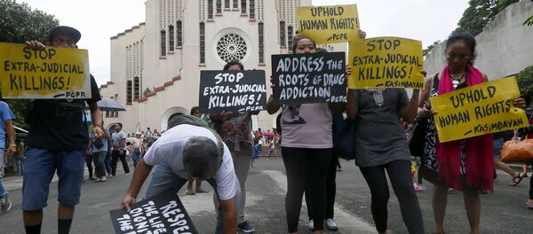 Human rights activists display placards outside the Baclaran Church prior to a mass in suburban Paranaque, south of Manila, Philippines. Human rights activists display placards outside the Baclaran Church prior to a mass in suburban Paranaque, south of Manila, Philippines. - Sputnik International