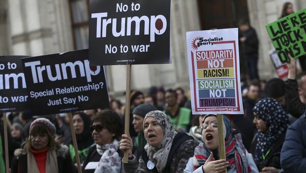 Demonstrators hold placards outside Downing Street during a march against U.S. President Donald Trump and his temporary ban on refugees and nationals from seven Muslim-majority countries from entering the United States, in London, Britain, February 4, 2017 - Sputnik International